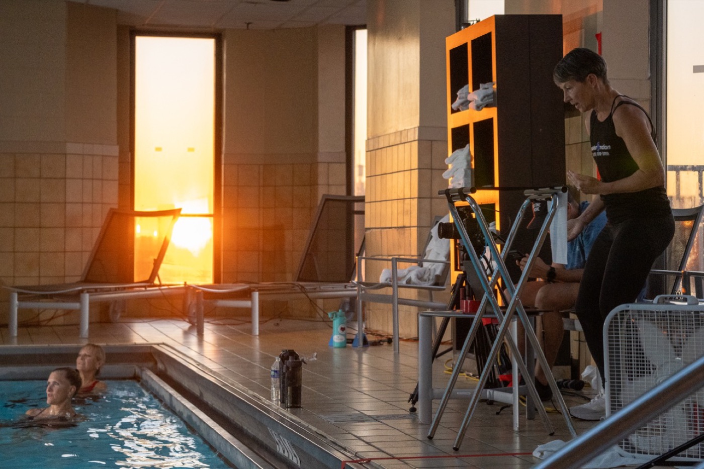 Aquatic fitness session at sunset in a hotel pool
