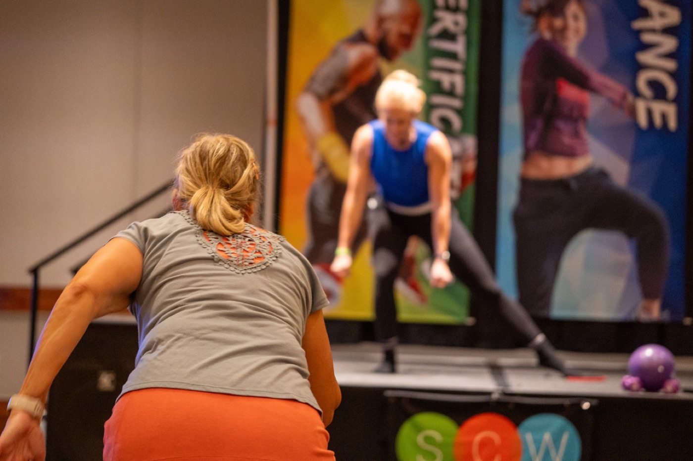 Participant performing a lunge during a convention workout