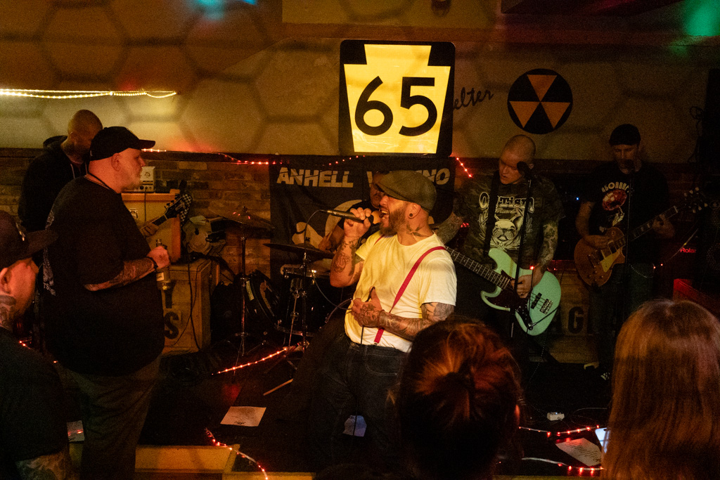 Wide shot of the band playing under the 65 sign