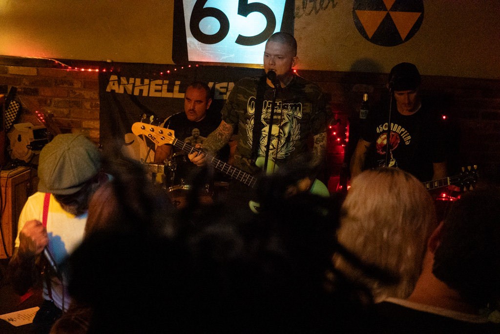 Crowd watching the band from the back of the room
