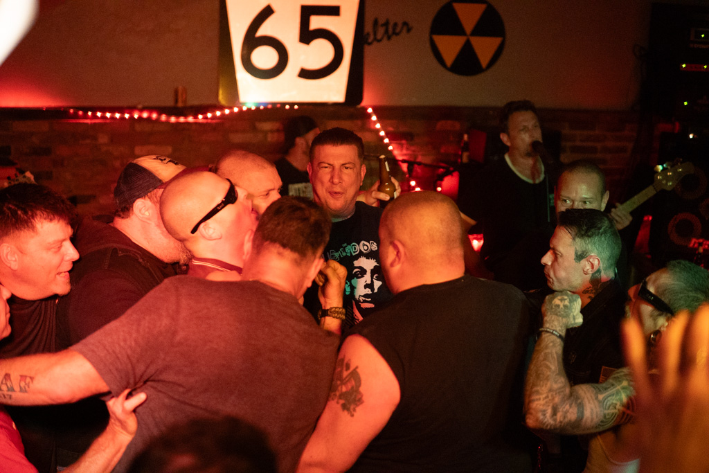 Fans moshing under the 65 sign